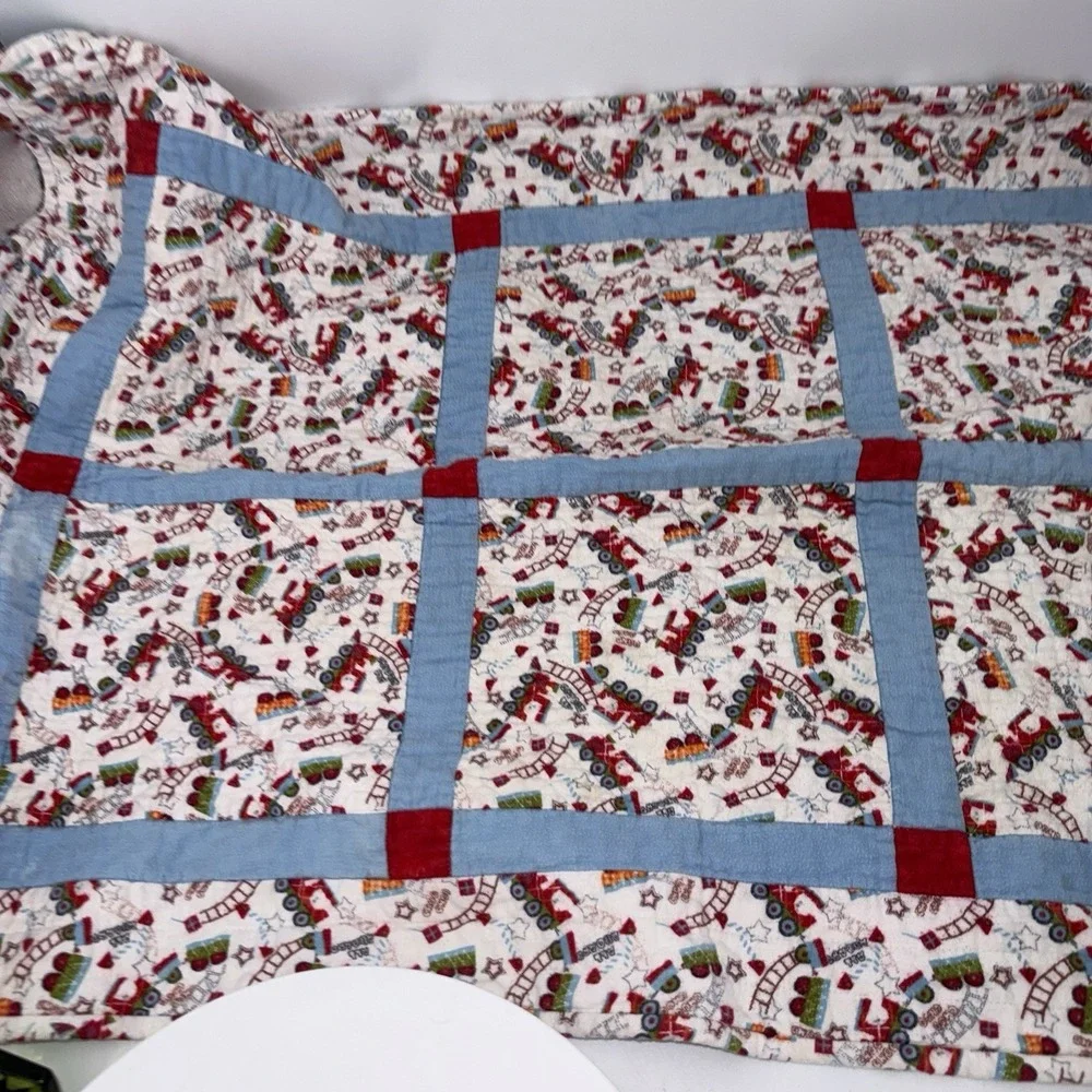 Vtg Baby Quilt Of Trains Print bordered by blue sashing and red cornerstones